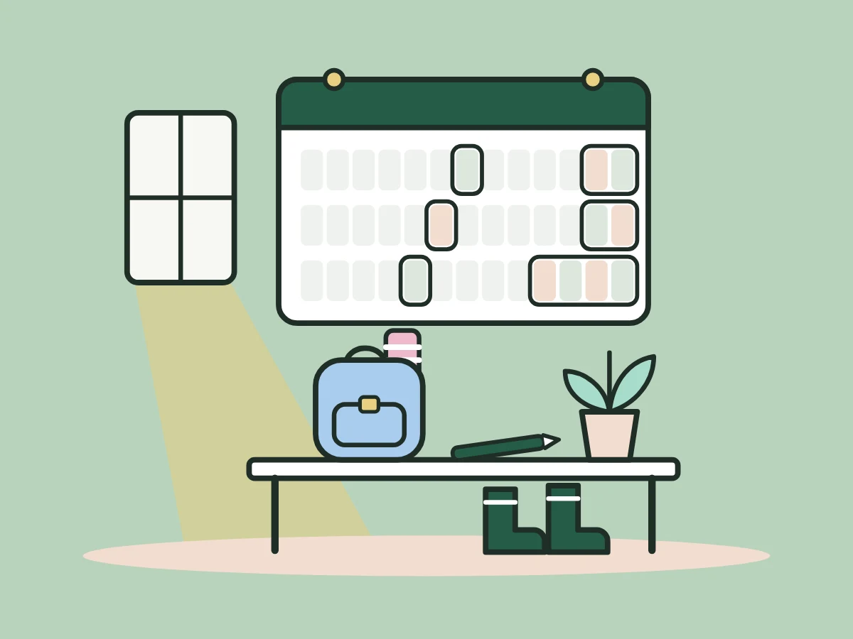 A year planner on the wall above a desk with a school backpack, a plant and wellies